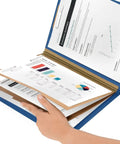 Peel And Stick Paper Fasteners 1 Inch Capacity 130 Count Tin Plated Steel Smooth Edge Clutch in use with documents in a folder.