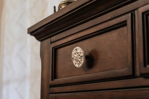 Rock Solid Compass Rose Drawer Pulls Set Of 12 In Antique White Cast Iron Nautical Cabinet Handles on a wooden dresser.