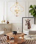 Room with Golden Orb Chandelier Four Light Pendant Ceiling Fixture In Candle Style Geometric Design above seating area.