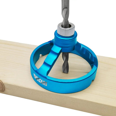 Pro Grade Drill Press Guide Jig with blue aluminum body and drill bushing for precise vertical hole in wood using electric hand drill.