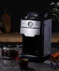 No Sweat Bean To Cup Coffee Maker With Fully Automatic One Button Brew Whisper Quiet Grind And Solid Stainless Steel Build featuring a glass carafe.