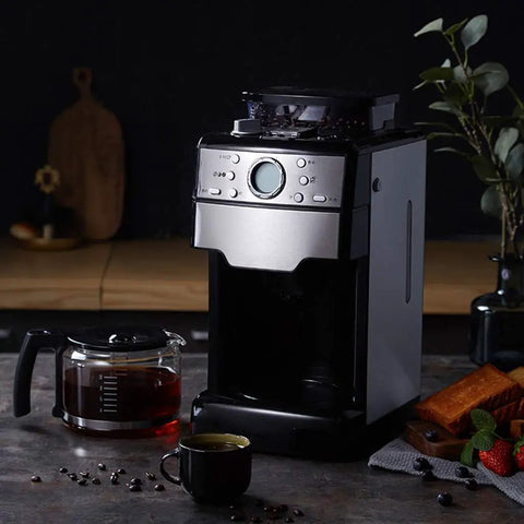 No Sweat Bean To Cup Coffee Maker With Fully Automatic One Button Brew Whisper Quiet Grind And Solid Stainless Steel Build featuring a glass carafe.