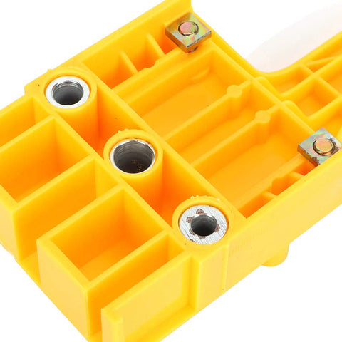 Close-up of the yellow Rock Solid Doweling Jig Kit 38 Piece Self Centering Woodworking Drill Guide with metal inserts.