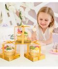 Child admiring cupcakes in Golden Cake Gift Boxes 30 Pack With Clear Viewing Windows Premium Dessert Packaging at party