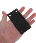 Hand holding a beefy heavy duty flat plate corner bracket with screws black 10x5cm set for tables and chairs no wobble deformation resistant.
