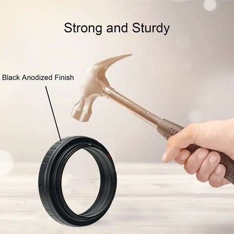 Hand holding a hammer above SV195 Wide 48mm T Ring Adapter for Canon EOS Cameras, showing strong black anodized finish for telescope use.