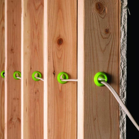 EZ Guard single-stud electrical wire protector green grommets installed in wooden studs with white wire (5-pack)