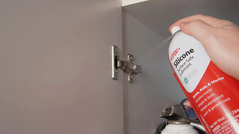Applying Silicone Lubricant With Teflon Fluoro Polymer For Non Metal Materials on cabinet hinge for smoother operation.
