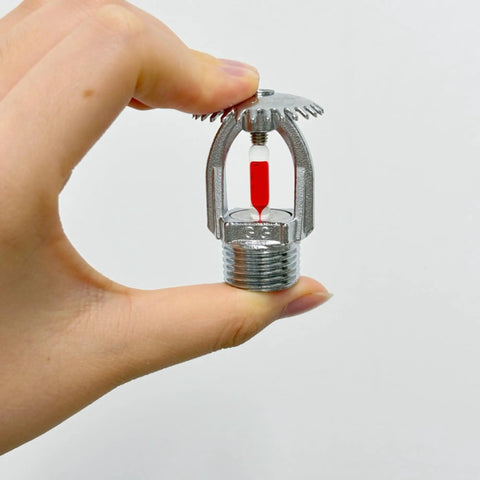 Five Pack Heavy Duty Chrome Brass Fire Sprinklers Automatic Thermal Trigger Built Like A Tank For Home And Business Up To Sixty Eight Degrees Celsius Three Quarter Inch Upright Design held with fingers.