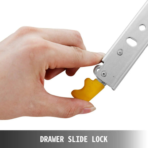 Heavy Duty Ball Bearing Drawer Slides With Lock And Smooth Glide Design Plus Fully Extended Cabinet Rails Featuring Smooth Operator Performance And Badass Durability Up To Two Hundred Twenty Kg Load Capacity Includes Mounting Hardware Pair, showing a hand engaging the drawer slide lock mechanism.