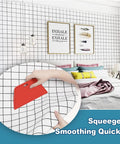 Pro Grade Wallpaper Smoothing Tool Kit For Peel And Stick DIY Projects, hand using squeegee on grid wallpaper in bedroom