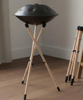 Hella Sturdy Steel Drum Rack With Solid Beech Wood Tripod Stand, portable with foam pads, adjustable for home grooves or live shows.