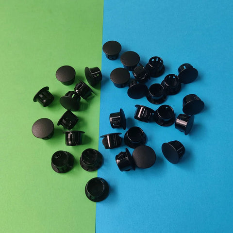 Thirty Pcs Black Plastic Hole Plugs For Cabinet And Screw Holes, 13 Mm Bottom Diameter, spread on colorful surface