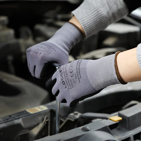 Pair of safety work gloves, gray seamless knit with micro-foam nitrile coating, worn while inspecting car engine