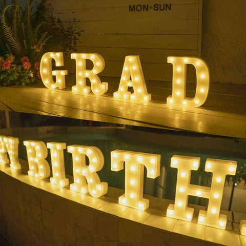 Must Have Light Up Letters Marquee Signs For Wedding Party And Home Decor, LED letter lights on display reading 'GRAD' and 'BIRTH'