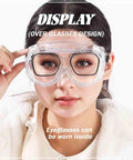 Woman wearing Anti-Fog Safety Goggles With Clear Lens For Industrial And Workshop Use, over regular eyeglasses, front view.