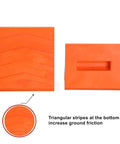 Orange heavy duty rubber wheel chocks for trailers with no slip curved design, showing triangular stripes for friction.
