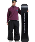 Person with snowboard wearing Baggy Snow Pants for Women and Men Insulated Snowboarding Trousers Waterproof Windproof Outdoor Gear Black Loose Fit