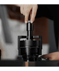 Hit Your Sweet Spot With This Heavy Duty Wdt Needle Distributor Engineered For 58mm Espresso Portafilters To Crush Stubborn Clumps And Elevate Your Roast Game, showing close-up of black stainless steel tool in use.