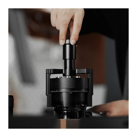 Hit Your Sweet Spot With This Heavy Duty Wdt Needle Distributor Engineered For 58mm Espresso Portafilters To Crush Stubborn Clumps And Elevate Your Roast Game, showing close-up of black stainless steel tool in use.