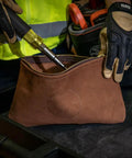 Person placing a screwdriver in a Top-Grain Leather Tool Pouch With Zipper Closure 12.5 Inch Brown Built Tough For Pliers And Wrenches