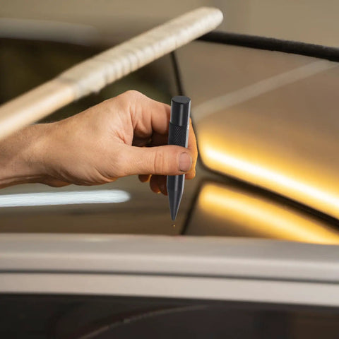 Hand holding scratch pen for car dent repair on car panel, Tough As Nails Auto Body Hammer And Car Dent Repair Pen For Quick Panel Fixes Effortlessly Smoothing Sheet Metal Dings On Your Daily Driver Rig With Durable Steel Build Black.