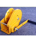 Heavy Duty Electric Hoist 2600 LB Manual Winch Hand Crank Self-Cranking Lifter with yellow steel body and handle for garage use.