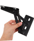 Hand holding spring-loaded folding sofa hinges showing durable build.