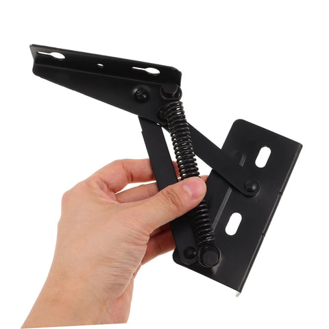 Hand holding spring-loaded folding sofa hinges showing durable build.