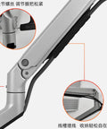 Close-up of heavy duty height adjustable monitor mount stand showing clamp and joint mechanism for ergonomic use.