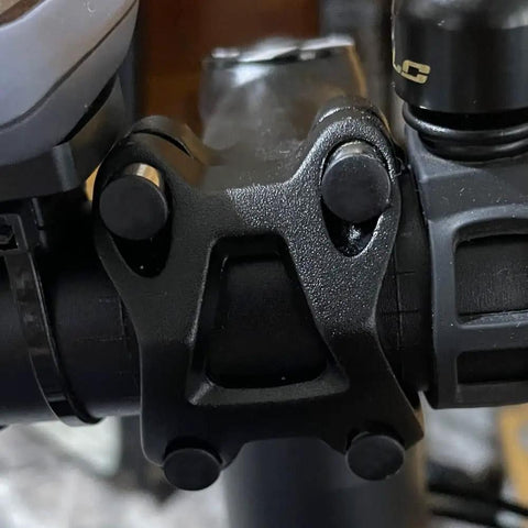 Close-up of hex bolt on bike handle with 50 Pack M5 And M6 Screw Caps Covers Hex Hole Anti Dust Nylon Locknut Stopper.