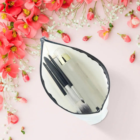 Funny Travel Makeup Bag For Women, Multiuse Cosmetic Case And Toiletry Organizer open with makeup brushes, surrounded by flowers