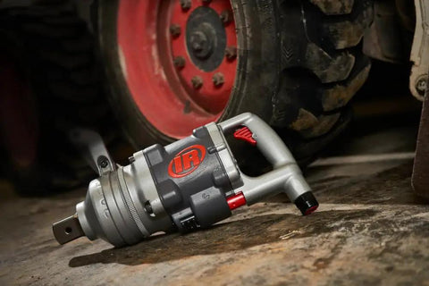 Heavy Duty 1 1/2 Inch Air Impact Wrench With D Handle resting on the ground, showcasing rugged design for tough garage work.
