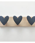 Gonna Keep Your Kid Room Looking Fresh With These Slick Wall Mounted Coat Hooks Shaped Like Cool Cars And Crowns To Hang Winter Coats Scarves And Caps Without Any Fuss Today. Black heart-shaped hooks on wood wall plate.