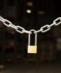 40mm Solid Brass Keyed Padlock Set, 2 Pack With 2.5 Inch Shackle Clearance securing chain in industrial setting