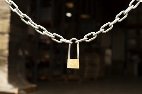 40mm Solid Brass Keyed Padlock Set, 2 Pack With 2.5 Inch Shackle Clearance securing chain in industrial setting