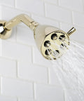 Polished Solid Brass Shower Head With Anystream Technology Three Settings Dope Water Flow For A Customizable Spa Like Shower Experience Durable Bathroom Fixture mounted on white tile