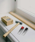 Heavy Duty Sliding Barn Door Rollers Built Tough For Large Widths Cold Rolled Steel Hardware on workbench with hammer and wood.