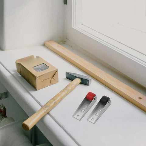 Heavy Duty Sliding Barn Door Rollers Built Tough For Large Widths Cold Rolled Steel Hardware on workbench with hammer and wood.