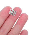 Mini Metal Hinge Set For Dollhouse Furniture And Jewelry Boxes, 10x8mm With Screws, Silver Tone, shown on fingertip