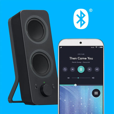 Bluetooth 2.0 Desktop Speakers With 3.5mm Aux Cable next to smartphone showing music app on blue background