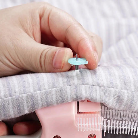 No Sweat Heavy Duty Handheld Sewing Gun Quick Clothing Repair Tool Featuring Pink Grip applying a plastic pin on fabric.