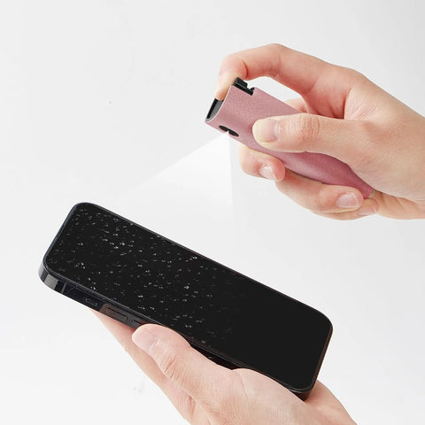 Touchscreen Mist Cleaner Kit With Spray And Wipe Pink Pocket Size Screen Cleaner For iPhone Android iPad MacBook Laptop Monitor Car Displays Tesla Reusable Easy To Carry Quick Dry After Cleaning in use on smartphone screen