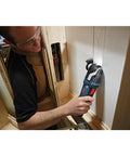 Person using the 18V EC Brushless Oscillating Multi Tool With StarlockPlus Quick Change System for precise plunge cuts in woodworking.