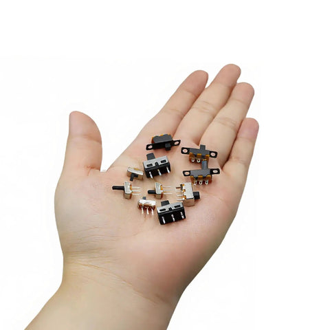 Person holding Awesome Micro Mini Slide Switch Kit 110Pcs SPDT 1P2T Toggle Switches with various models like SS12D00