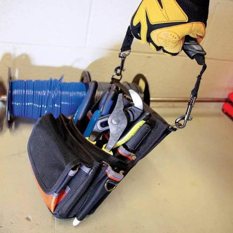 Tradesman Pro Tool Pouch With Electrical Tape Thong And Reinforced Bottom in use showing filled pockets and carrying via strap.