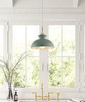 11inch Wood Pendant Light,Retro Wooden Hanging for Kitchen Island with matte green metal shade in bright window setting.