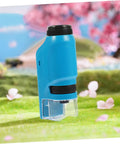 High Definition Handheld Microscope For Students Pocket Sized Biology Lab Accessory outdoors on grass