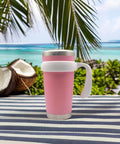 Pink tumbler with Anti Slip 20 Oz Tumbler Handle With Comfy Grip For Vacuum Insulated Travel Mugs in white on a tropical background.