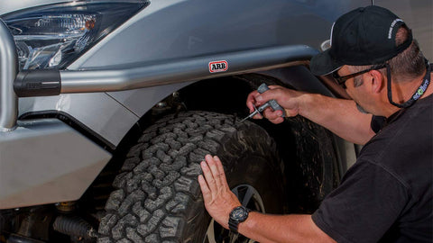 Man using Speedy Seal 2 Universal Heavy Duty Tire Repair Kit For Car, Truck, RV, Jeep, ATV, Motorcycle, Tractor And Trailer.